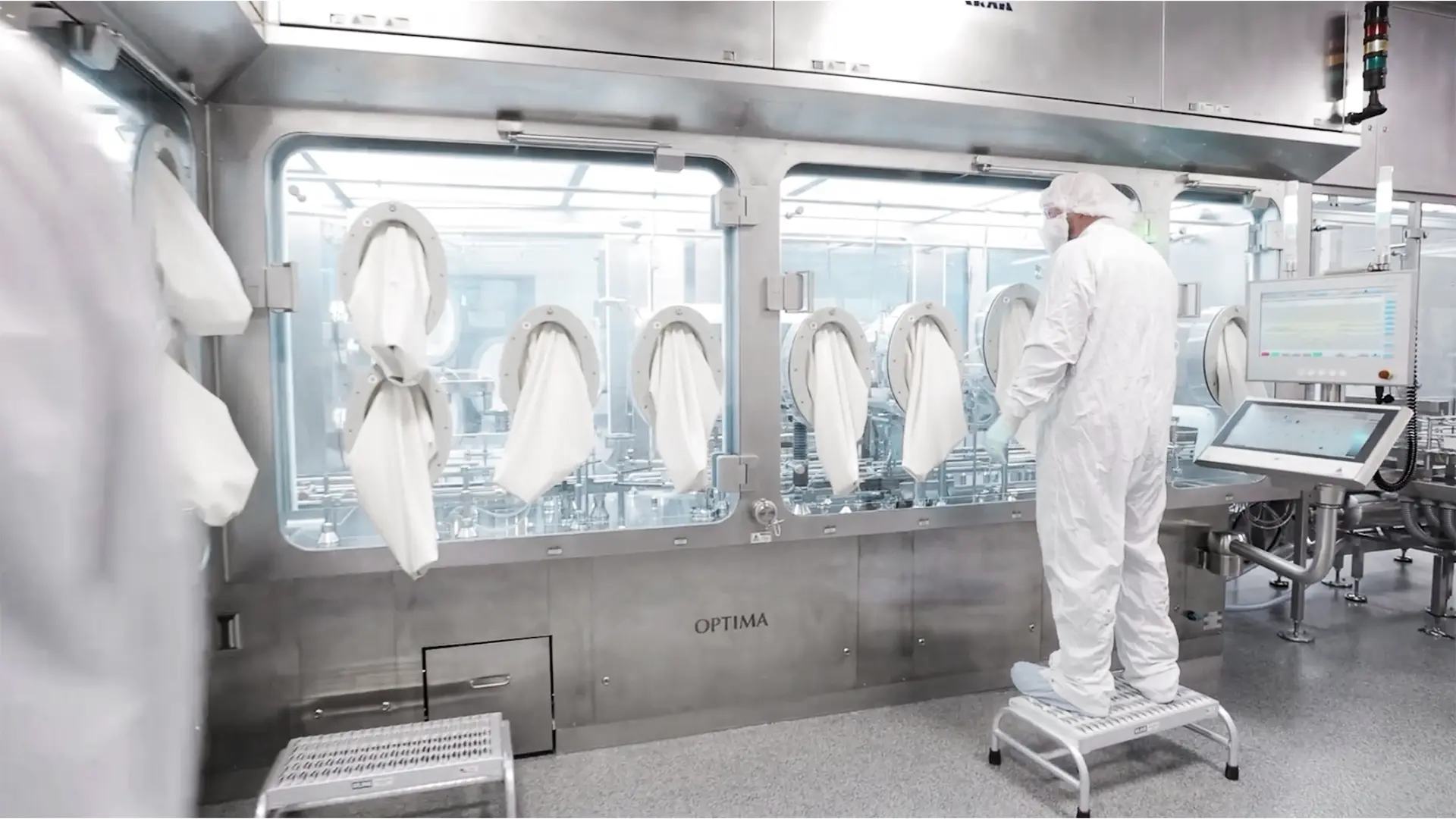 Scientists working within a high-containment isolator during the development and manufacturing of ultra-high potency targeted protein degraders (TPDs) and advanced small-molecule therapies
