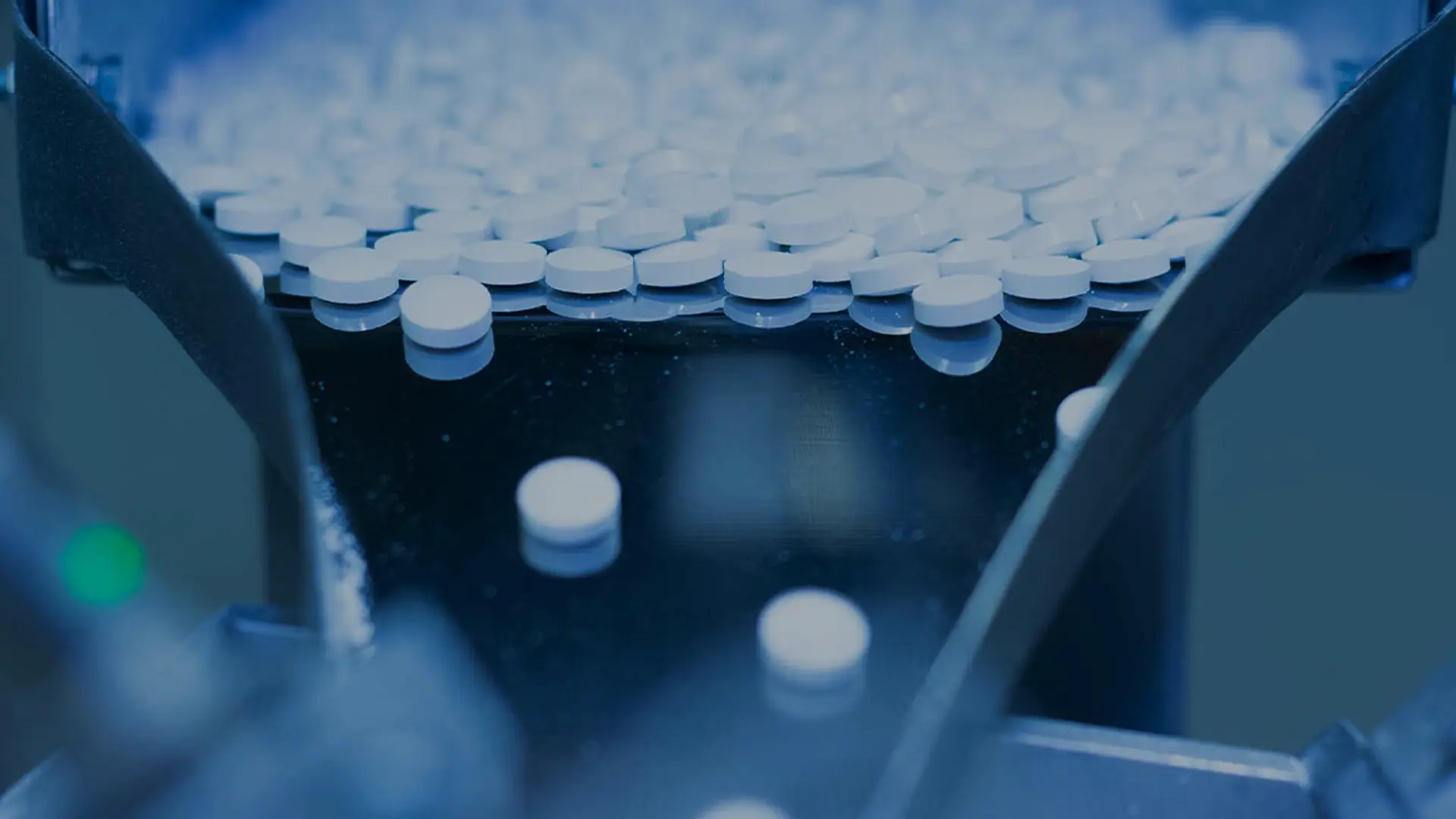 Pharmaceutical tablets undergoing roller compaction and dry granulation during oral solid dose manufacturing to improve powder flow and product consistency.